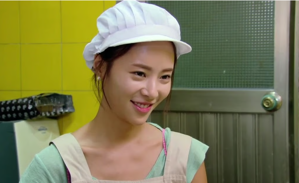 Hwang Jung-eum wearing a white bakery hat and apron in a scene from Secret Love (2013).