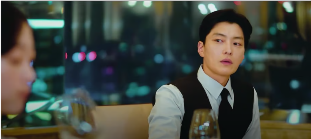 Jang Seung-jo in a dress shirt and vest seated across from a woman at a dinner table in As You Stood By